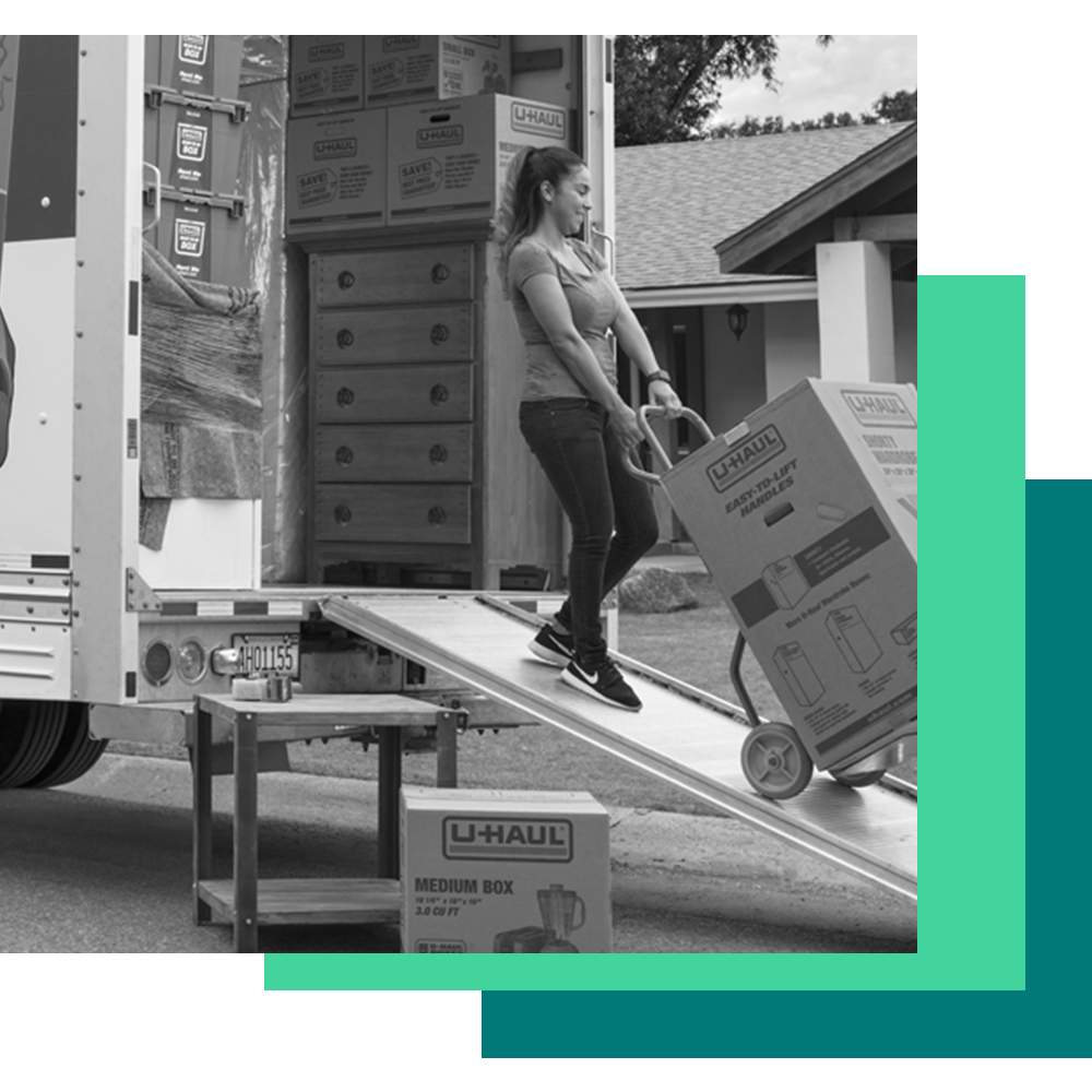 U-haul graphic of a woman unloading a moving truck with a box.